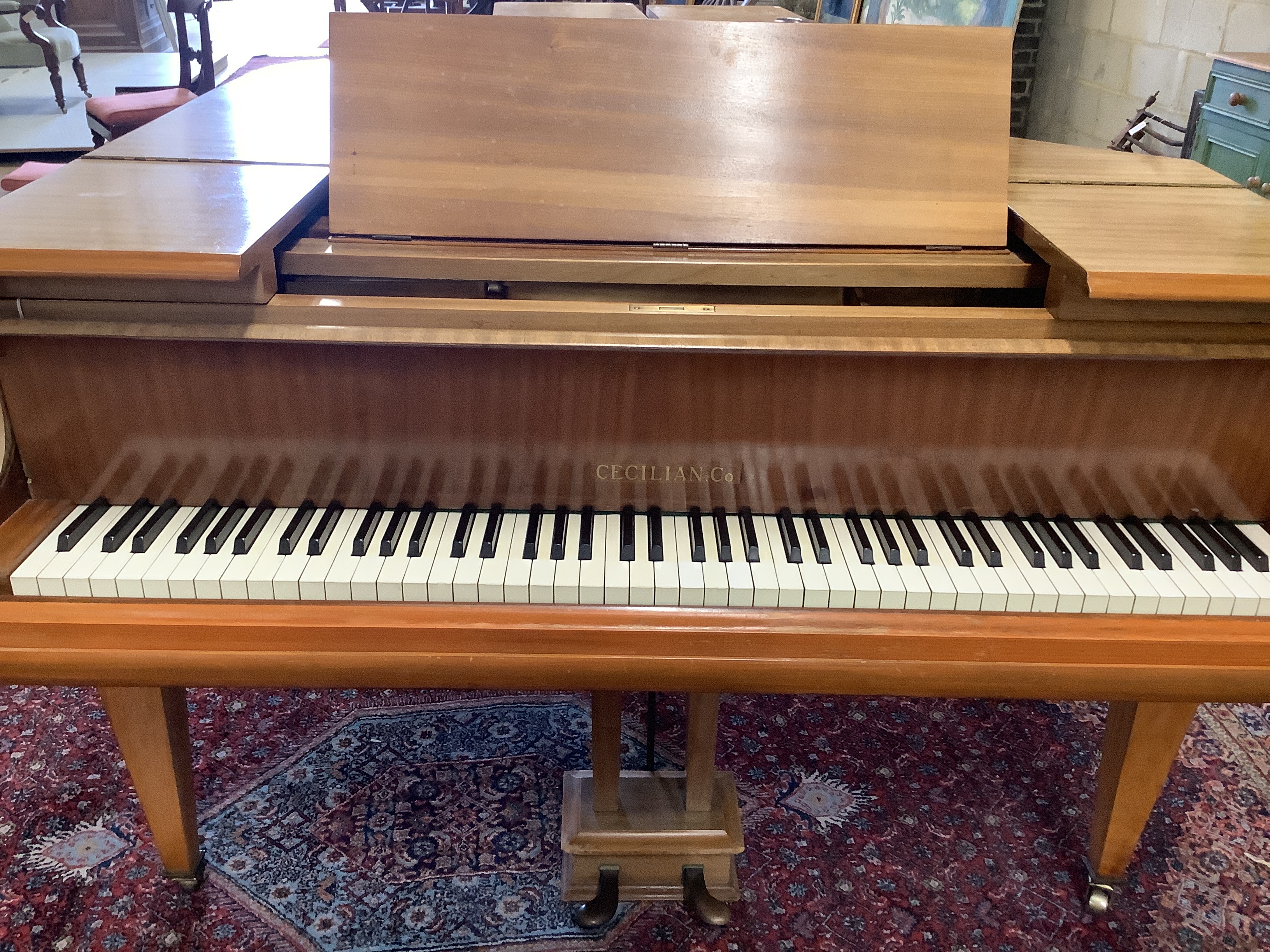 A mid 20th Cecilian & Co mahogany baby grand piano retailed by Harrods Ltd